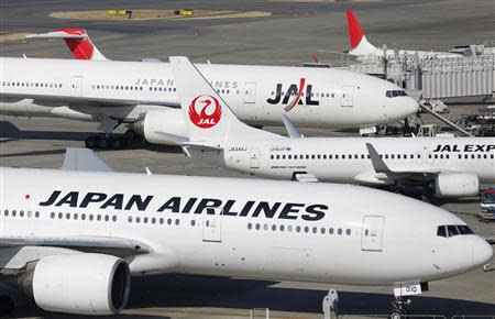 Japan Airlines aircrafts are parked on the tarmac at Haneda Airport in Tokyo February 4, 2013. REUTERS/Toru Hanai