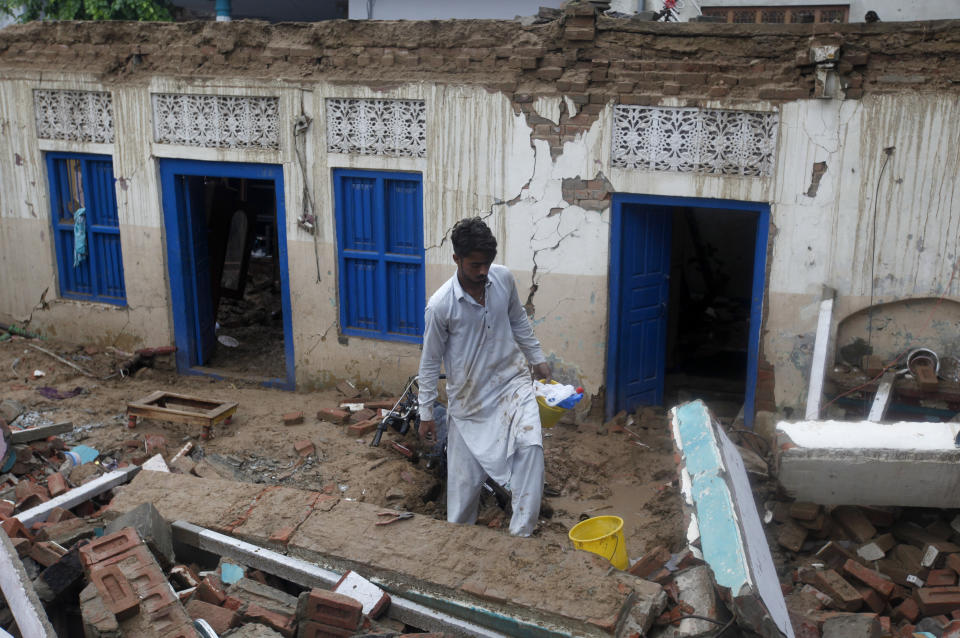 A man recovers belongings from the rubble of his damaged home caused by a powerful earthquake that struck Sahang Kikri village near Mirpur, in northeast Pakistan, Wednesday, Sept. 25, 2019. A powerful earthquake struck northeast Pakistan Tuesday, badly damaging scores of home and shops and killing some people and injured over 700, officials, said. (AP Photo/Anjum Naveed)