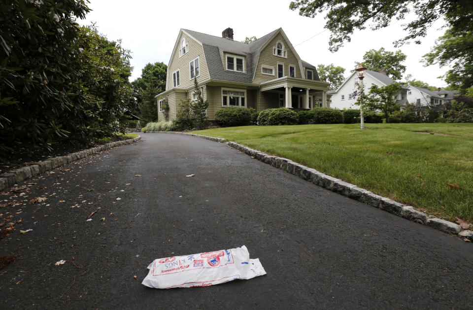 A newspaper rests unpicked on the driveway of a home, Thursday, June 25, 2015, in Westfield, N.J. Derek and Maria Broaddus said they were scared away from their new $1.4 million home because of creepy letters from a stalker. The couple has sued the sellers for not telling them about a person with a "mentally disturbed fixation" on the house. (AP Photo/Julio Cortez)
