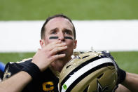 New Orleans Saints quarterback Drew Brees waves to his family and fans after an NFL divisional round playoff football game against the Tampa Bay Buccaneers, Sunday, Jan. 17, 2021, in New Orleans. The Buccaneers won 30-20. (AP Photo/Brynn Anderson)