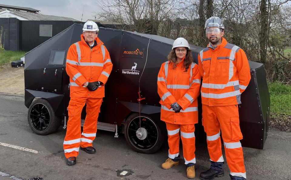 Cllr Reena Ranger, Chris Allen-Smith and Sebastiano Fichera, Co-Founder Robotiz3d with The ARRES PEVENT robot. Photo released March 8 2024. See SWNS story SWLSpothole.A 'revolutionary' new AI robot has been deployed on British roads in a world first to prevent the formation of potholes. The Autonomous Road Repair System (ARRES) spent its first-ever successful outing filling cracks in the roads of Hertfordshire with tar. The clever robot - officially named ARRES PEVENT - used artificial intelligence (AI) to detect defects in the road and fill them in before they form potholes - saving time and money as well as endless irritation to drivers. The droid, which uses state-of-the-art imaging technology, is the creation of tech company Robotiz3d and academics from the University of Liverpool, in collaboration with highways engineers at Hertfordshire County Council (HCC). 
