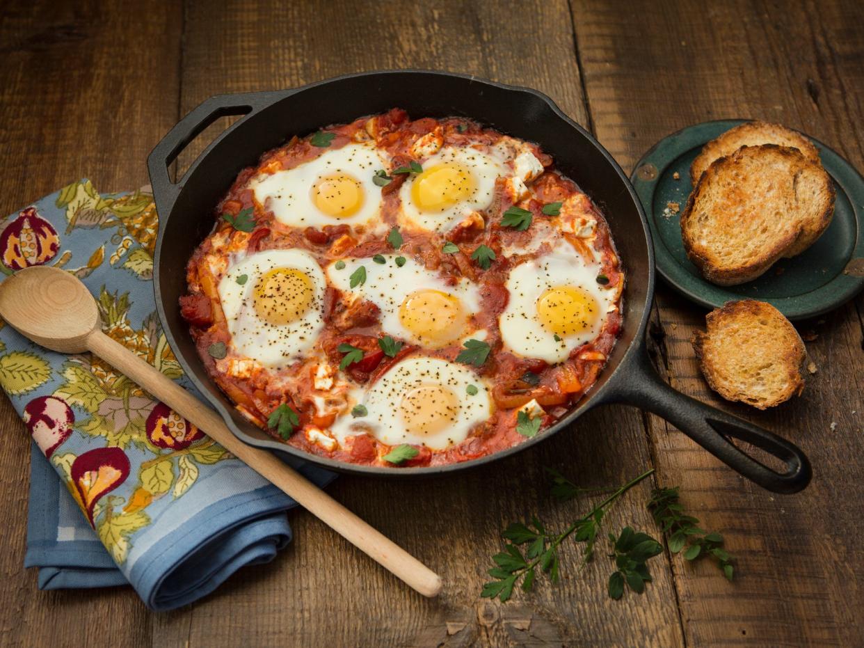 Overhead view of shakshouka on a rustic background.