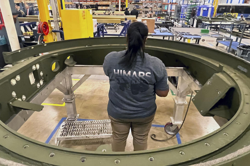 Lockheed Martin senior assembler Jadulin King, works on the base of an M270 Multiple Launch Rocket System (MLRS) at the company's weapons plant, Thursday, March 14, 2024 in Camden, Ark. Joint Chiefs Chairman Gen. CQ Brown visited the plant with lawmakers to talk about the need to pass the Ukraine supplemental and the direct economic impact the spending will have on these local workforces. (AP Photo/Tara Copp)