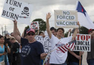 FILE - In this June 7, 2021, file photo, demonstrators at Houston Methodist Baytown Hospital in Baytown, Texas, wave at cars that honk at them to support their protest against a policy that says hospital employees must get vaccinated against COVID-19 or lose their jobs. A federal judge dismissed their lawsuit, saying if workers don’t like the rule, they can go find another job. (Yi-Chin Lee/Houston Chronicle via AP)