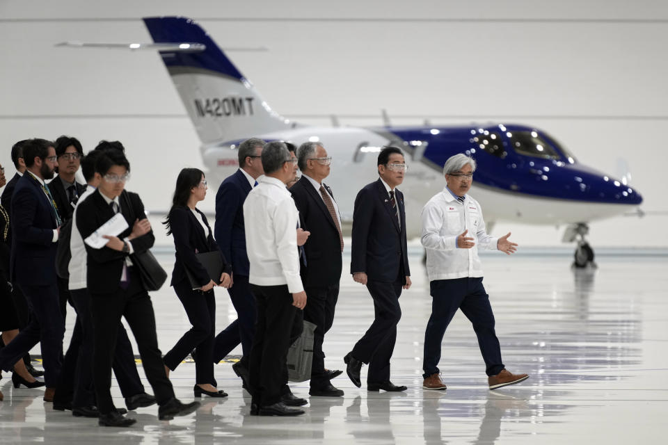 Japanese Prime Minister Fumio Kishida, second from right, walks through the assembly building during a visit to the Honda Aircraft facility in Greensboro, N.C., Friday, April 12, 2024. (AP Photo/Chuck Burton)