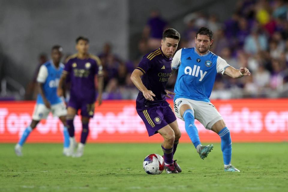 Orlando City SC midfielder Mauricio Pereyra (10) in action against Charlotte FC midfielder Brandt Bronico (13) during the first half at Exploria Stadium.