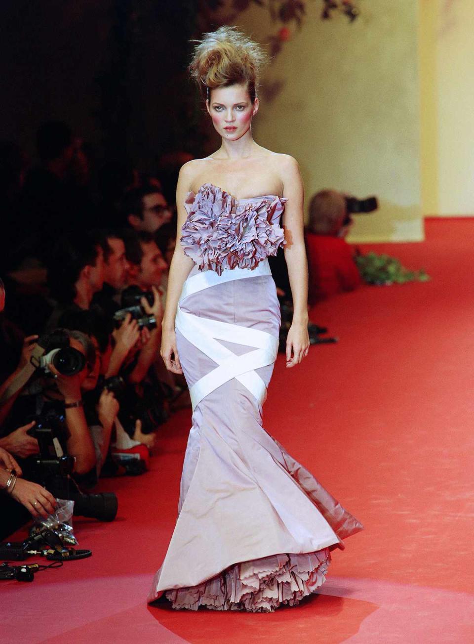 <p>Moss gave off Marie Antoinette vibes with a bouffant updo and heavily rouged cheeks at Vivienne Westwood's 1997 Spring/Summer ready-to-wear collection in Paris. </p>