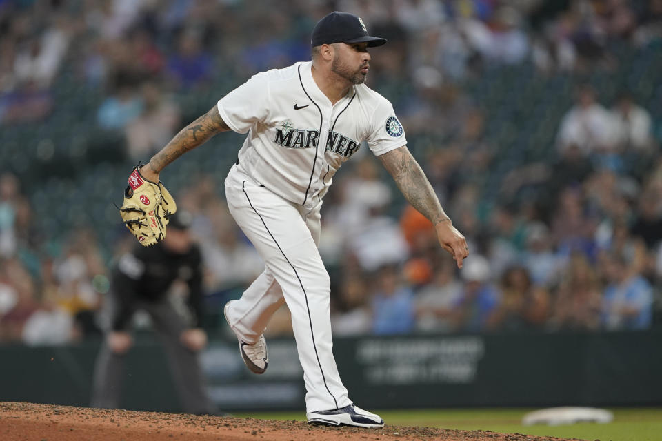 Seattle Mariners pitcher Hector Santiago watches a delivery during the fifth inning of the team's baseball game against the Houston Astros, Tuesday, July 27, 2021, in Seattle. It was the first game back for Santiago after he served a 10-game suspension for violating MLB's rules for foreign substances that could aid in pitching. (AP Photo/Ted S. Warren)