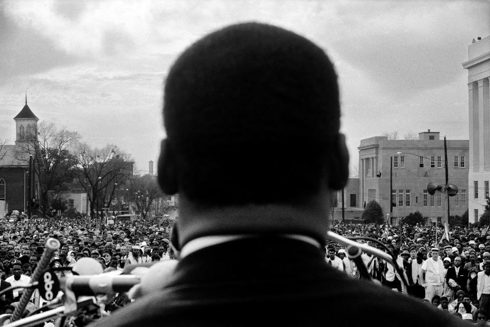 Dr. Martin Luther King, Jr. seen close from the rear, speaking to 25,000 civil rights marchers in front of the Alabama state capital building, at the conclusion of the Selma to Montgomery march, Montgomery, Alabama, March 25, 1965.<span class="copyright">Stephen Somerstein—Getty Images</span>