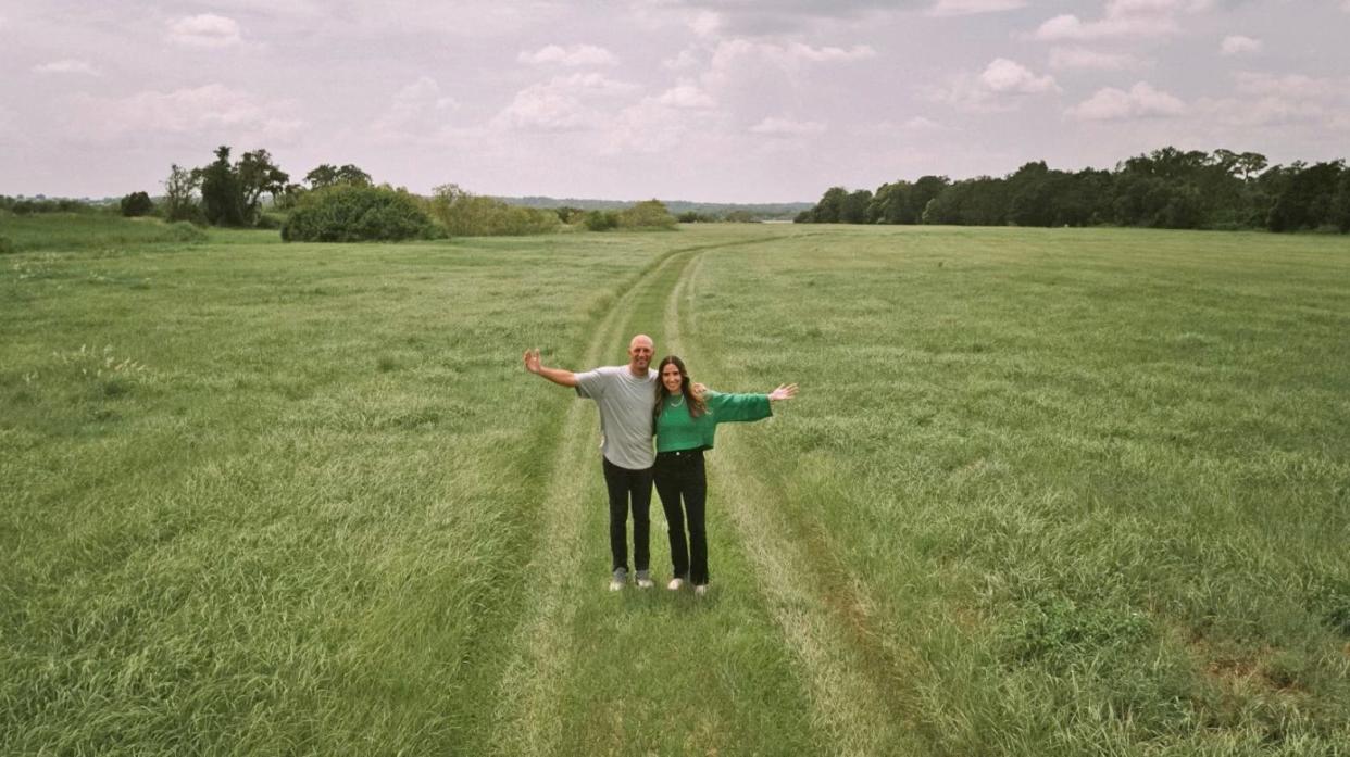 Andrew and Christina Gard, senior pastors at Grace City Church, stand on the 50-acre property at which the church plans to build a new campus. Leaders hope to break ground in the fall on the main church building, which will contain a 1,700-seat auditorium.