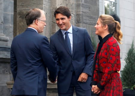 Canada's PM Justin Trudeau and his wife Sophie Gregoire Trudeau are greeted by Privy Council Clerk Ian Shugart as they arrive at Rideau Hall in Ottawa