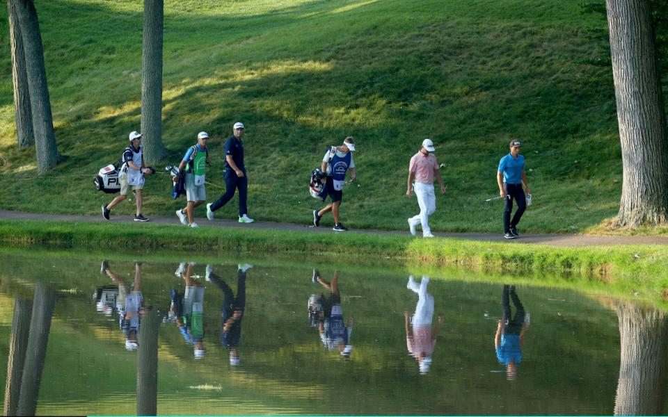 Viktor Hovland of Norway, Gary Woodland of the United States and Jon Rahm of Spain walk to the 12th green during the first round of the Workday Charity Open on July 09, 2020 at Muirfield Village Golf Club in Dublin, Ohio - GETTY IMAGES