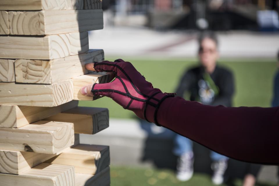 Trenton Reynolds plays a game of jumbo Jenga.