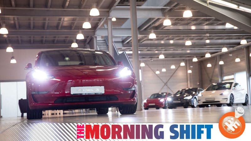 A photo of a red Model 3 EV at a Tesla facility. 