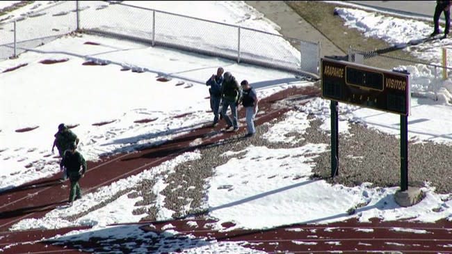 In this still image taken from video provided by Fox 31 Denver, police respond to reports of a shooting at Arapahoe High School in Centennial, Colo. Friday, Dec. 13, 2013. Colorado division of emergency management spokeswoman Micki Trost said her director went to the school and their weren't any more immediate details. (AP Photo/KDVR) MANDATORY CREDIT