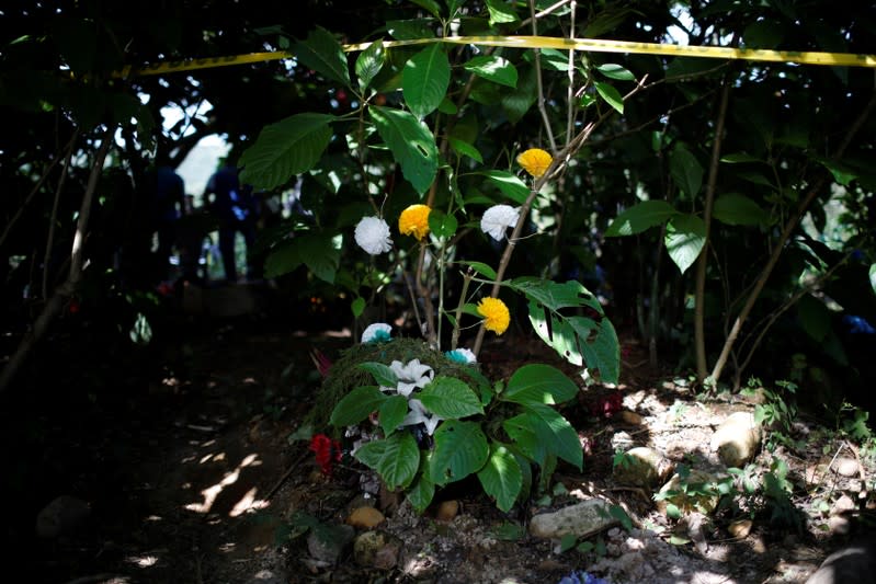 Wreaths and flowers are seen at an exhumation site in the village of Yancolo as a forensic team searches for human remains of the El Mozote massacre in the town of Cacaopera
