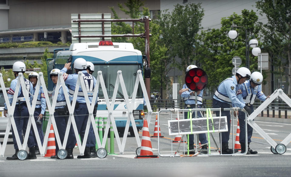 Police officers control traffic near the venue of G20 Finance Ministers and Central Bank Governors Meeting in Fukuoka, southern Japan Sunday, June 9, 2019. (AP Photo/Eugene Hoshiko)