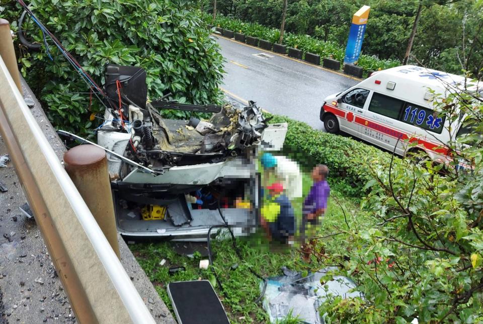 新北市貢寮區台2線龍洞路段今天中午發生貨櫃車和聯結車相撞事故，其中聯結車的車頭斷裂掉落邊坡，2名司機受困車內，警消獲報到場救援，將2男1女送醫，其中60多歲女子意識不清。（讀者提供）
