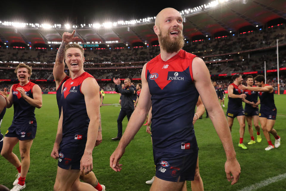 Seen here, Melbourne Demons players celebrate their preliminary final win over Geelong.