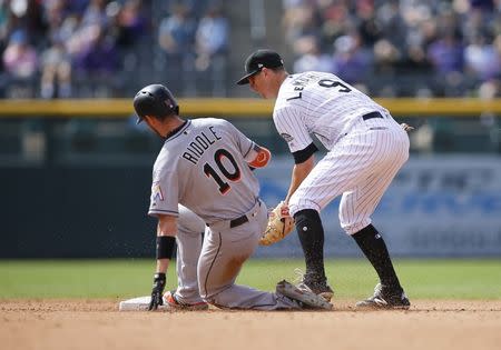 Jun 24, 2018; Denver, CO, USA; Miami Marlins infielder JT Riddle (10) slides into second base ahead of the tag by Colorado Rockies infielder DJ LeMahieu (9) for an RBI double in the fourth inning at Coors Field. Mandatory Credit: Russell Lansford-USA TODAY Sports