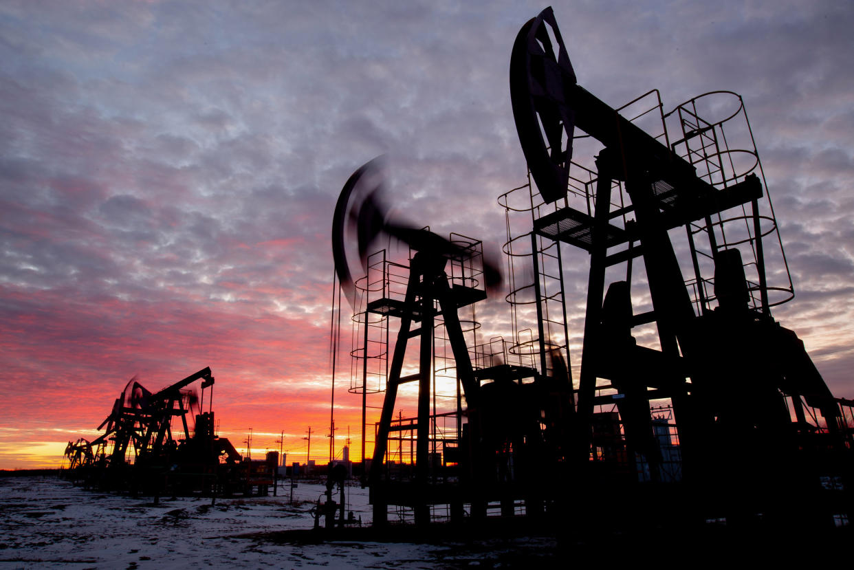 Oil pumping jacks in an oil field at sunset in Russia. Photographer: Andrey Rudakov/Bloomberg