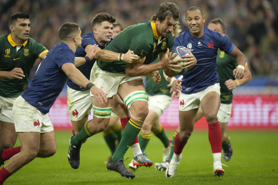 South Africa's Eben Etzebeth battles through to score a try during the Rugby World Cup quarterfinal match between France and South Africa at the Stade de France in Saint-Denis, near Paris Sunday, Oct. 15, 2023. (AP Photo/Christophe Ena)