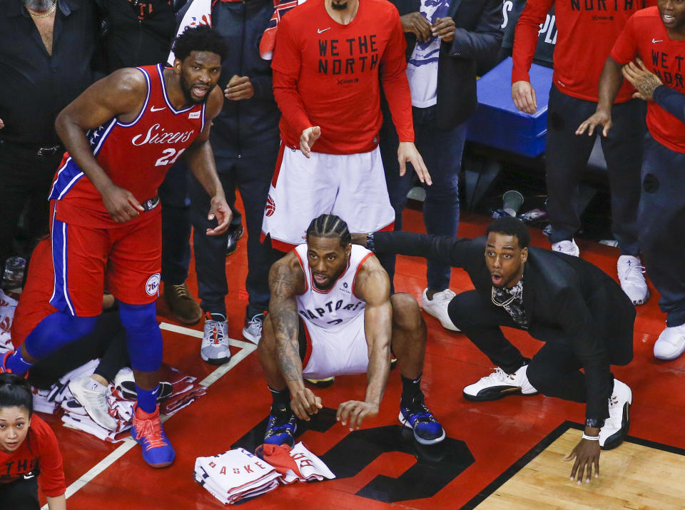 Philadelphia 76ers center Joel Embiid #21 watches from the corner as Toronto Raptors forward Kawhi Leonard #2 squats down and sticks out his tongue waiting for the ball to drop for Raptors to win. (Photo by Rick Madonik/Toronto Star via Getty Images)