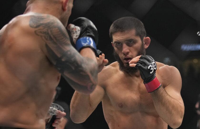 FILE - Islam Makhachev of Russia, right, battles Alex Volkanovski of Australia in the UFC lightweight championship fight during UFC 294, at the Ethihad Arena in Abu Dhabi, United Arab Emirates, Saturday, Oct. 21, 2023. Makhachev defends his UFC lightweight championship against Dustin Poirier in the main event of UFC 302 on Saturday, June 1, 2024, in New Jersey. (AP Photo/Kamran Jebreili, File)