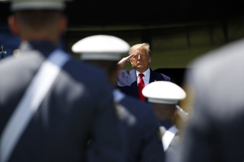 President Donald Trump salutes after speaking to over 1,110 cadets in the Class of 2020 at a commencement ceremony on the parade field, at the United States Military Academy in West Point, N.Y., Saturday, June 13, 2020. (AP Photo/Alex Brandon)
