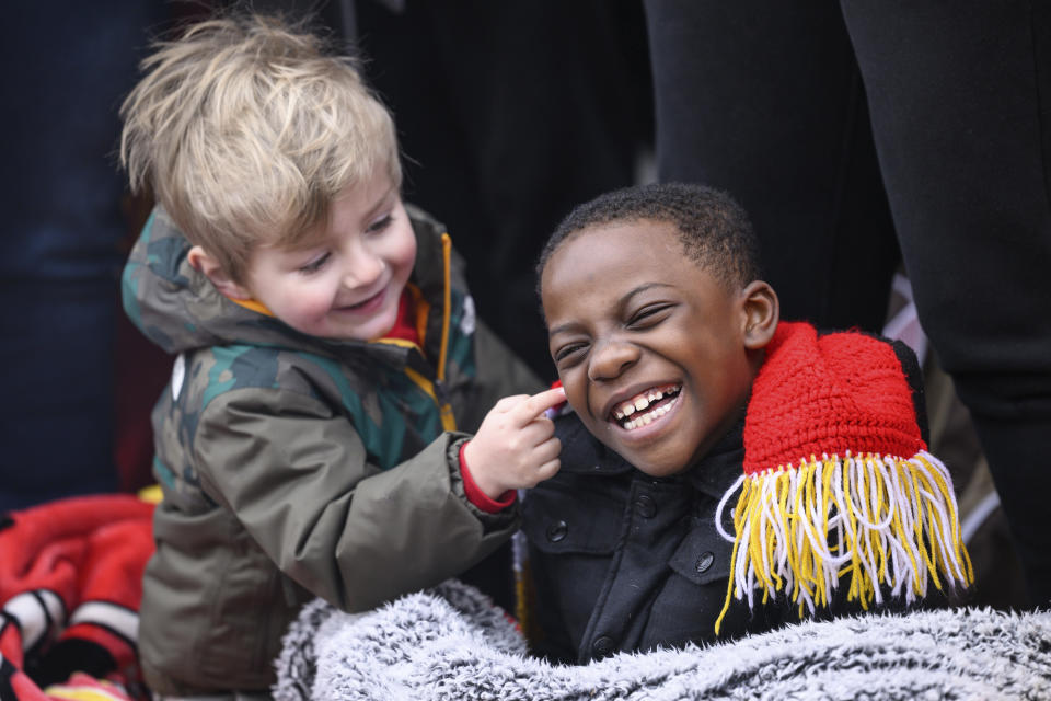 A couple of young Chiefs fans make the most of the morning waiting for the Kansas City Chiefs' victory celebration and parade in Kansas City, Mo., Wednesday, Feb. 15, 2023. The Chiefs defeated the Philadelphia Eagles Sunday in the NFL Super Bowl 57 football game. (AP Photo/Reed Hoffmann)
