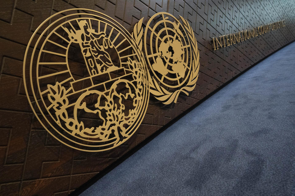 The logo of the International Court of Justice, left, and the U.N. sit on the judges bench as preliminary hearings opened in a case in which the Netherlands and Canada are suing Syria at the International Court of Justice, or World Court, the United Nations' highest judicial organ, in The Hague, Netherlands, Tuesday, Oct. 10, 2023, accusing Damascus of massive human rights violations against its own people. (AP Photo/Peter Dejong)