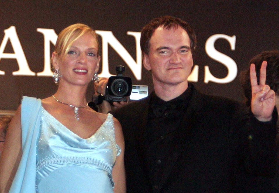 U.S. director Quentin Tarantino (R) gives the 'V' sign as he stands with actress Uma Thurman (R) during red carpet arrivals for the world premier of Tarantino's film, 'Kill Bill Vol. 2' which is screen out of competition at the 57th Cannes Film Festival, May 16, 2004. REUTERS/Vincent Kessler (FRANCE)