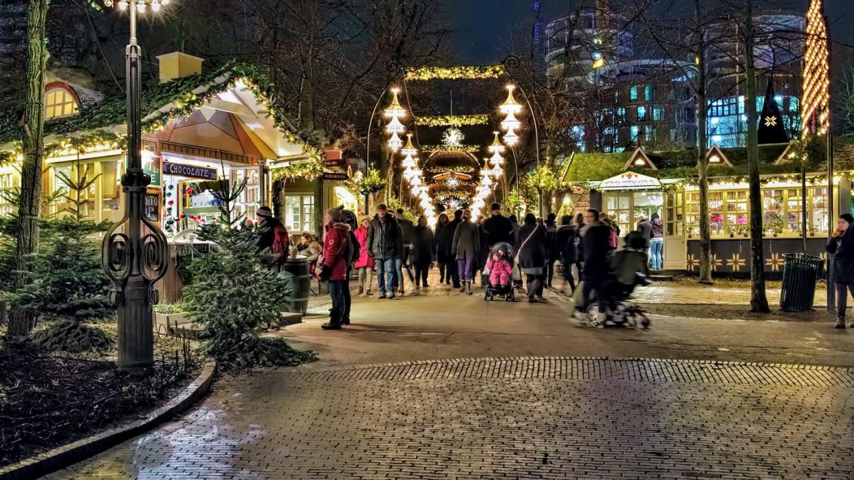 copenhagen, denmark december 14, 2015 christmas market in tivoli gardens in dusk tivoli gardens is a famous amusement park and pleasure garden it is the most visited theme park in scandinavia