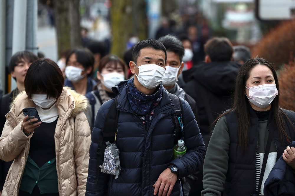 People wearing protective face masks are seen before a rehearsal of the Tokyo 2020 Olympic Torch Relay in Hamura, outskirts of Tokyo February 15, 2020. — Reuters pic