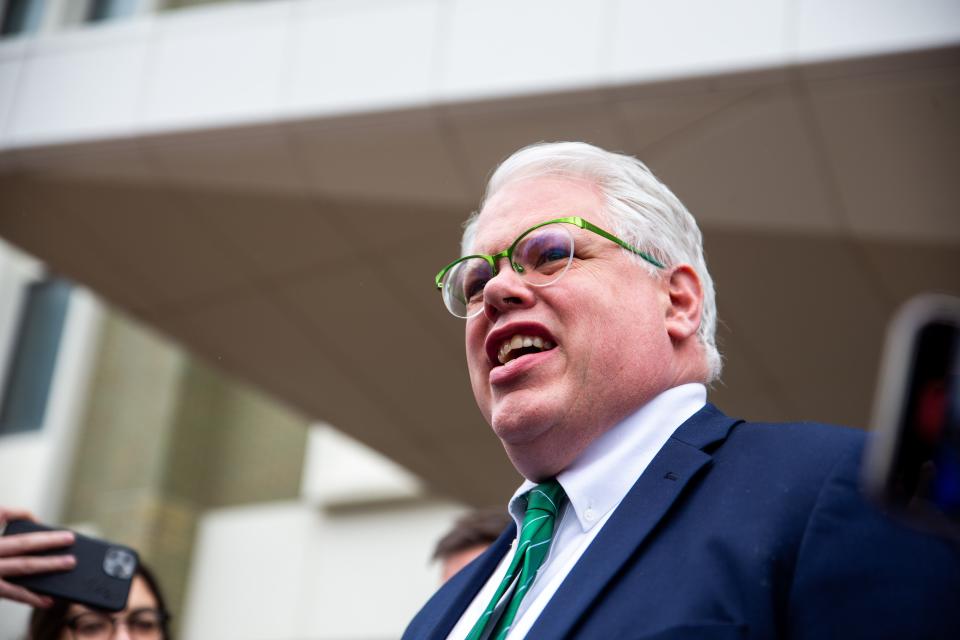 Chris Gibbons walks to a crowd of media to answer questions Friday, April 8, 2022, at the Gerald R. Ford Federal Building in downtown Grand Rapids. The jury is deadlocked on Gibbons's client Adam Fox and a mistrial was declared.