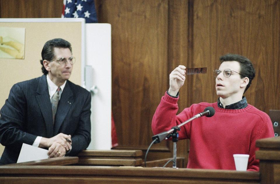 Defense attorney Barry Levin watches Erik Menendez as he looks at negatives of photos taken by his father.