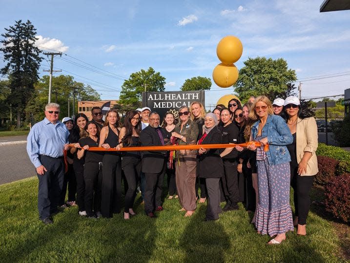 Staff at All Health Medical celebrate a ribbon cutting at their new Westwood location on Old Hook Road on May 8.