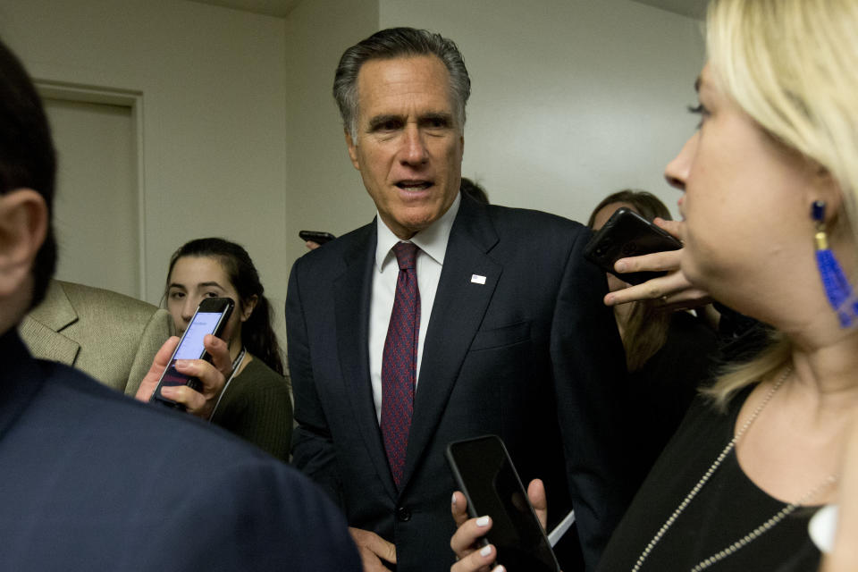 Sen. Mitt Romney, R-Utah, talks to reporters as he walks to attend the impeachment trial of President Donald Trump on charges of abuse of power and obstruction of Congress, Tuesday, Jan. 28, 2020, on Capitol Hill in Washington. (AP Photo/Jose Luis Magana)