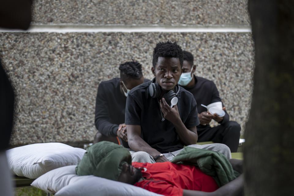 Migrants rest at the refugee camp in the village of Verebiejai, some 145km (99,1 miles) south from Vilnius, Lithuania, Sunday, July 11, 2021. Migrants at the school in the village of Verebiejai, about 140 kilometers (87 miles) from Vilnius, haven't been allowed to leave the premises and are under close police surveillance. Some have tested positive for COVID-19 and have been isolated in the building. (AP Photo/Mindaugas Kulbis)