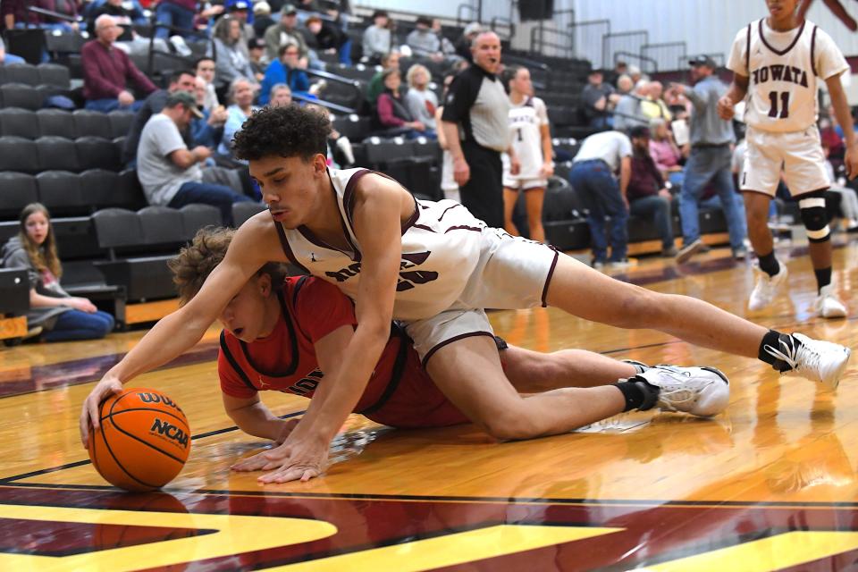 Nowata High School's Talon Thompson (20) dives to the floor with South Coffeyville's Brycen Bauer (12) during basketball action in Nowata on Jan. 11, 2024.