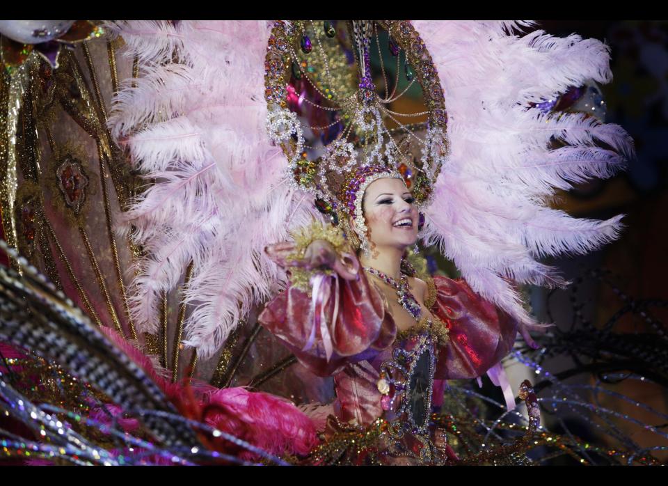 A nomine for Queen of the Santa Cruz carnival shows off her outfit under the watchful eyes of the jury at Santa Cruz de Tenerife on the Spanish Canary island of Tenerife, February 15, 2012. (DESIREE MARTIN/AFP/Getty Images)