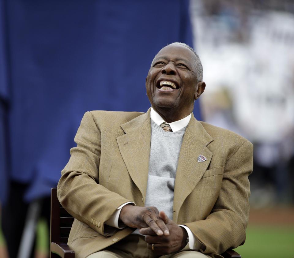 Hank Aaron laughs during a ceremony celebrating the 40th anniversary of his 715th home run before the start of a baseball game between the Atlanta Braves and the New York Mets, Tuesday, April 8, 2014, in Atlanta. (AP Photo/David Goldman)