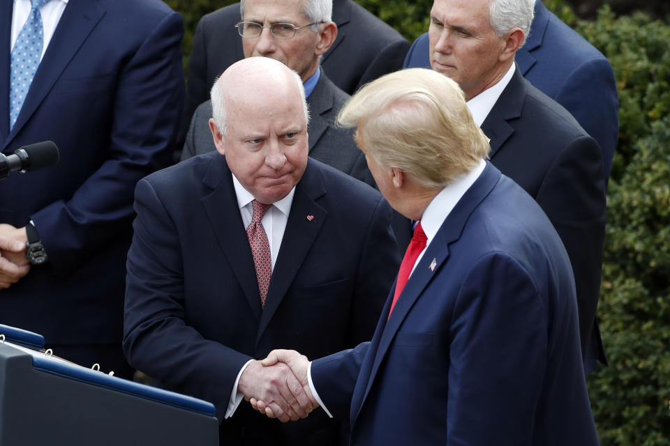 President Donald Trump shakes hands with Thomas Moriarty, Executive Vice President of CVS Health, during a news conference about the coronavirus in the Rose Garden at the White House, Friday, March 13, 2020, in Washington. (AP Photo/Alex Brandon)