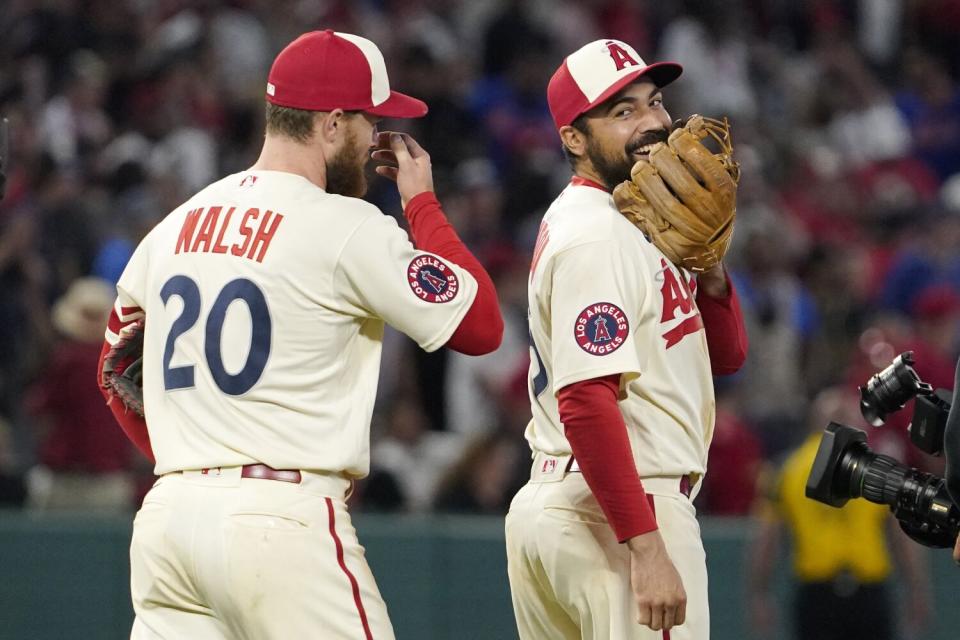 Angels teammates Jared Walsh, left, and Anthony Rendon laugh during a game against the New York Mets in June.