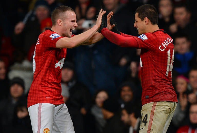 Manchester United's Tom Cleverley (L) celebrates with Javier Hernandez after Hernandez scored the winner against Newcastle at Old Trafford in Manchester on December 26, 2012. United will look to put even more daylight between themselves and rivals Manchester City when they host West Bromwich Albion on Saturday, as the Premier League's busy festive season continues