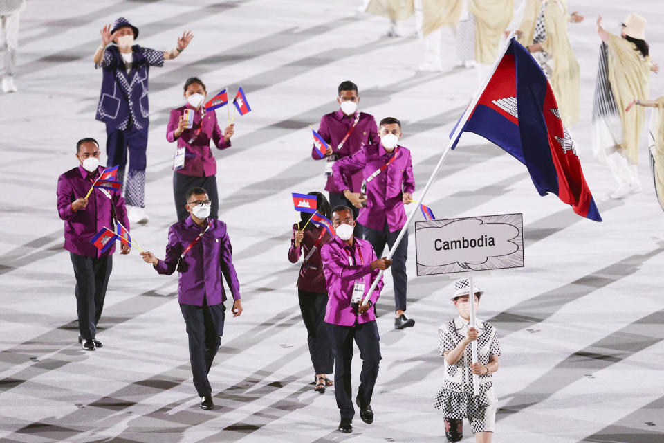 <p>TOKYO, JAPAN - JULY 23: Flag bearers Bunpichmorakat Kheun and Sokong Pen of Team Cambodia lead their team during the Opening Ceremony of the Tokyo 2020 Olympic Games at Olympic Stadium on July 23, 2021 in Tokyo, Japan. (Photo by Patrick Smith/Getty Images)</p> 