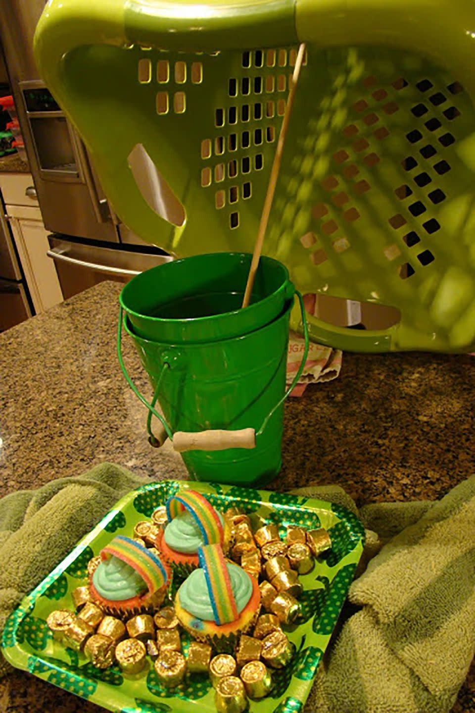 green laundry basket leprechaun trap with gold rolos and pot of gold cupcakes for bait, easy st patricks day craft for kids