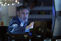 Trader John Romolo works on the floor of the New York Stock Exchange, Monday, Nov. 29, 2021. Stock indexes are edging higher on Wall Street Monday as markets regain their footing following a big stumble on Friday on worries about the spread of the new variant of the coronavirus. (AP Photo/Richard Drew)