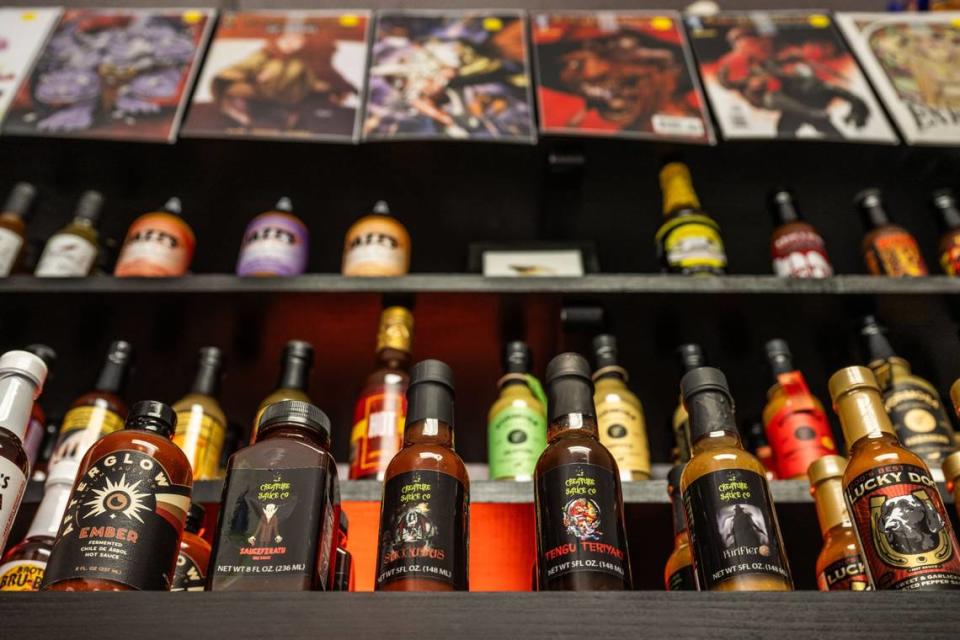 A selection of hot sauce and comic books are displayed at Empire’s Comics Vault & Hot Sauce in Arden Arcade.