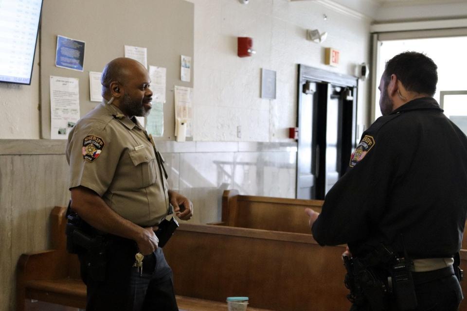 Travis County sheriff's Deputies Trent Roe, left, and Joshua Eisman talk during a break at the Sweatt Travis County Courthouse, where Gamble presides. She has seen an increase in threats as a result of some high-profile cases.